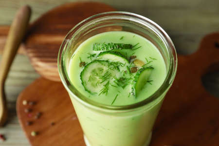 Glass with cold cucumber soup on table, closeupの写真素材