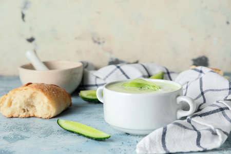 Pot with cold cucumber soup on tableの写真素材