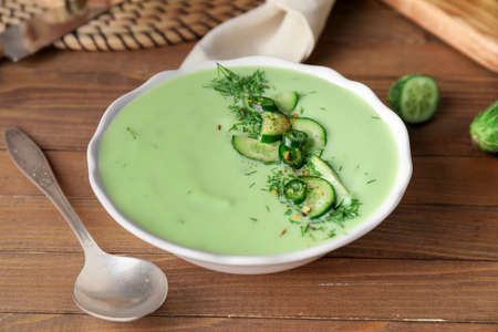 Bowl with cold cucumber soup on tableの写真素材