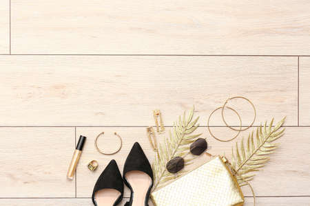Set of female accessories on light wooden backgroundの写真素材