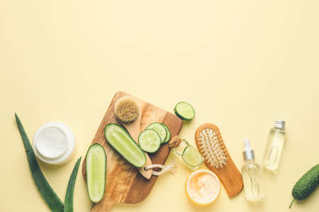 Composition with cucumber and cosmetics on color backgroundの写真素材