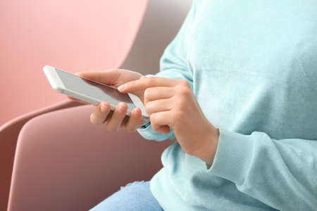 Woman with mobile phone at home