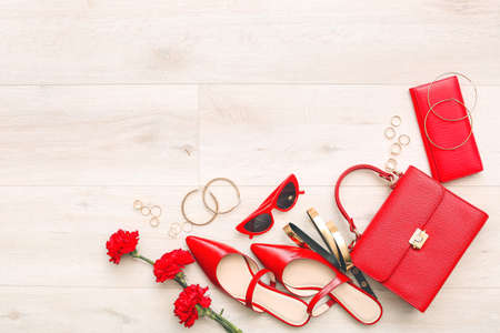Set of female accessories on light wooden backgroundの写真素材