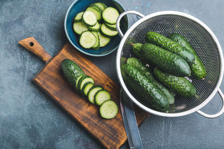 Composition with fresh green cucumbers on tableの写真素材