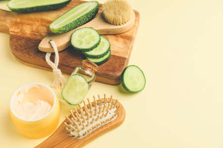 Composition with cucumber and cosmetics on color backgroundの写真素材