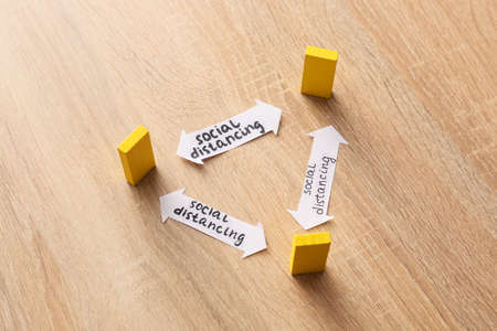 Composition with blocks on wooden background. Concept of social distance