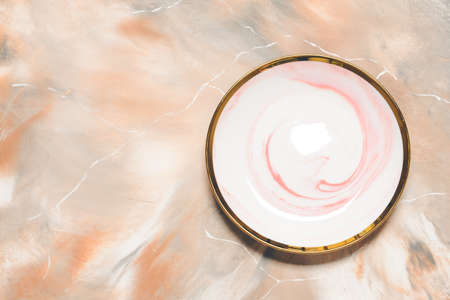 Ceramic plate on marble backgroundの写真素材