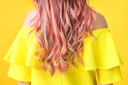 Beautiful young woman with unusual hair on color background, closeupの写真素材