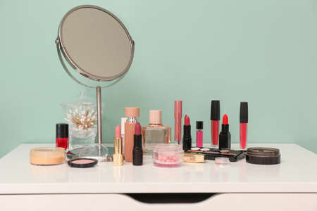 Makeup cosmetics on chest of drawers in dressing roomの写真素材