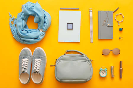 Female accessories on color background