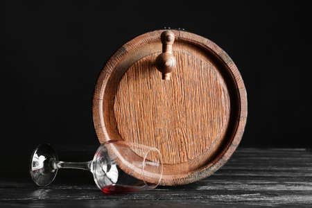 Wooden barrel of wine and glass on dark backgroundの写真素材