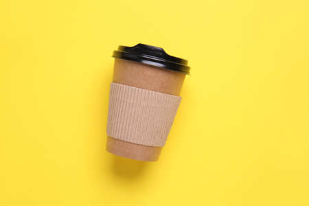 Takeaway cup for drink on color background