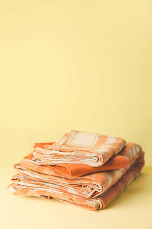 Stack of clean bed sheets on color backgroundの写真素材