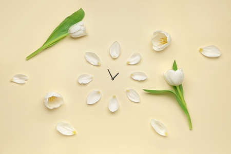 Clock made of flowers on color background. Spring timeの写真素材