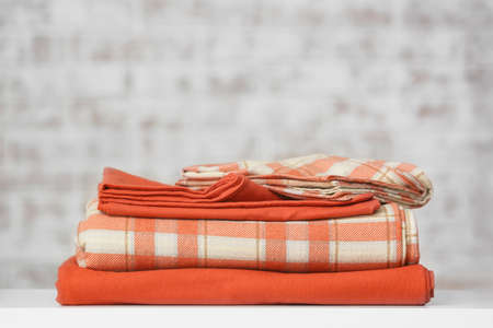 Stack of clean bed sheets on tableの写真素材