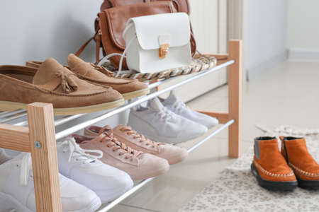 Stand with stylish shoes in interior of modern hallの写真素材