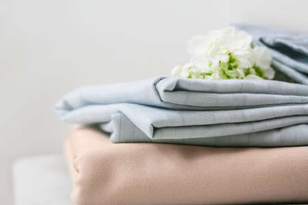 Stack of clean bed sheets on table, closeupの写真素材