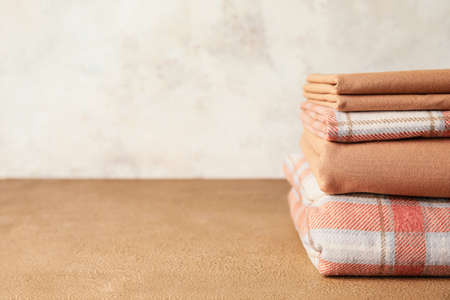 Stack of clean bed sheets on tableの写真素材