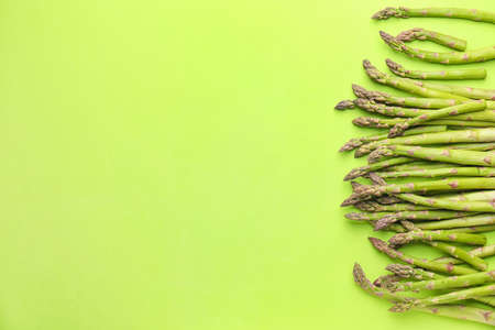 Fresh asparagus on color backgroundの写真素材