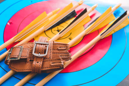 Arrows and protective equipment for archery on targetの写真素材
