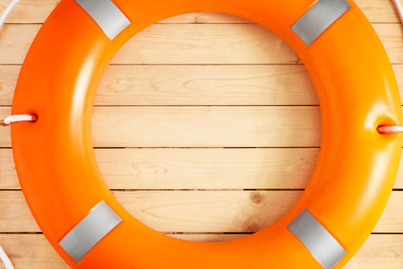 Lifebuoy ring on wooden background