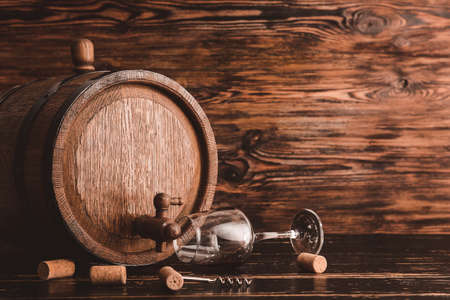 Wooden barrel of wine and glass on tableの写真素材