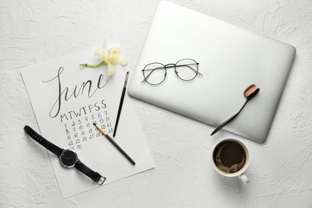 Composition with cup of coffee, laptop and calendar on white background