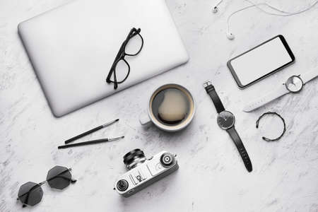 Composition with cup of coffee, laptop and photo camera on white backgroundの写真素材