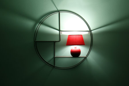 Glowing lamp on shelf in eveningの写真素材
