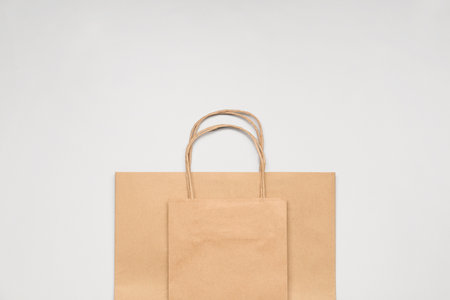 Paper shopping bags on gray background