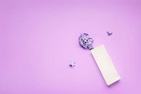 Paper bag with flowers on color backgroundの写真素材