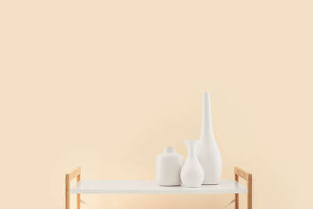 Table with vases in empty roomの写真素材