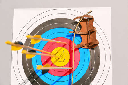 Target for archery with arrows, bow and protective gear outdoors