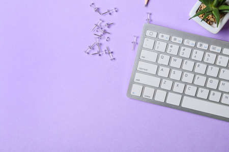 Set of stationery and PC keyboard on color backgroundの写真素材