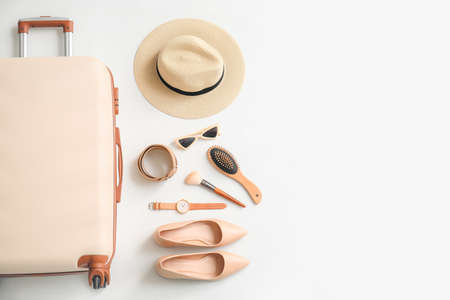 Packed suitcase and accessories on white backgroundの写真素材