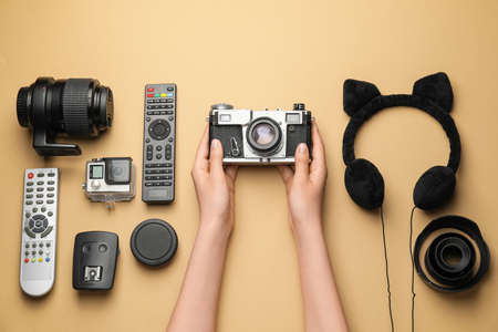 Female hands with different modern devices on color background