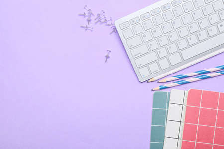 Set of stationery and PC keyboard on color backgroundの写真素材