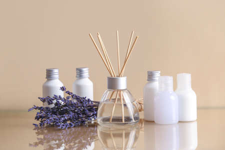 Reed diffuser, lavender and cosmetics on tableの写真素材
