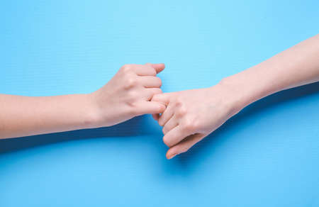 Pinky grip on color background. Unity conceptの写真素材
