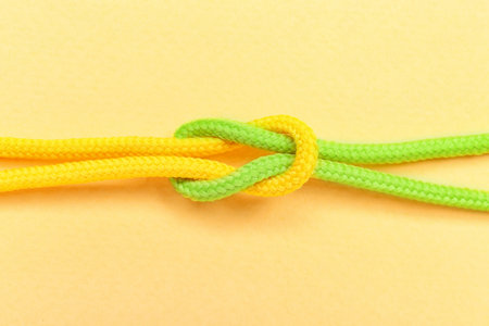 Tied ropes on color background. Unity concept