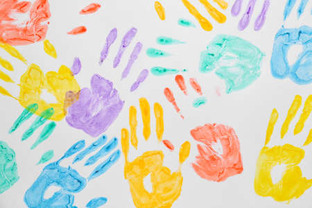 Colorful human palm prints on white background. Unity concept