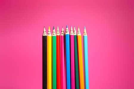 Colorful pencils with drawn faces on pink background. Unity conceptの写真素材