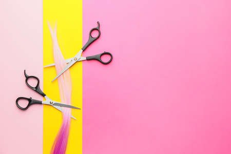 Hairdresser scissors with strand on color backgroundの写真素材
