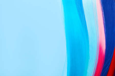 Colorful hair strands on color backgroundの写真素材