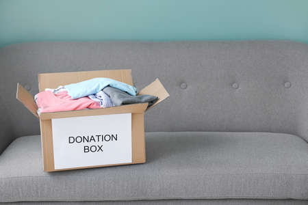 Box with donations on sofaの写真素材