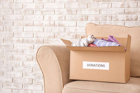 Box with donations on sofaの写真素材