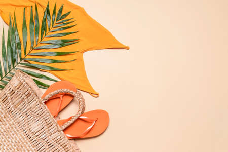 Straw bag with beach clothes on light backgroundの写真素材