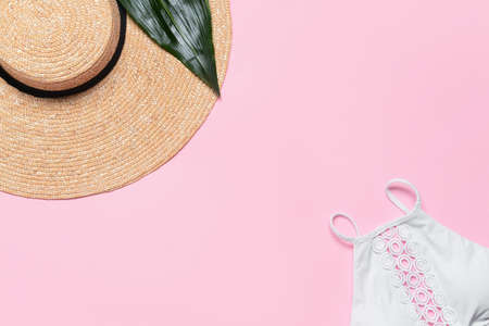 Straw hat with swimsuit on color backgroundの写真素材