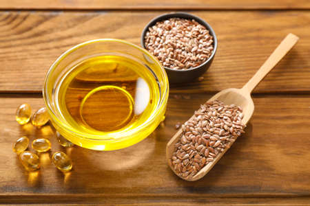 Composition with flax oil on wooden tableの写真素材