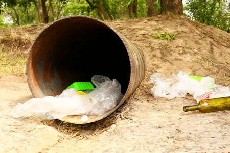Sewer pipe with trash outdoors. Concept of soil pollution